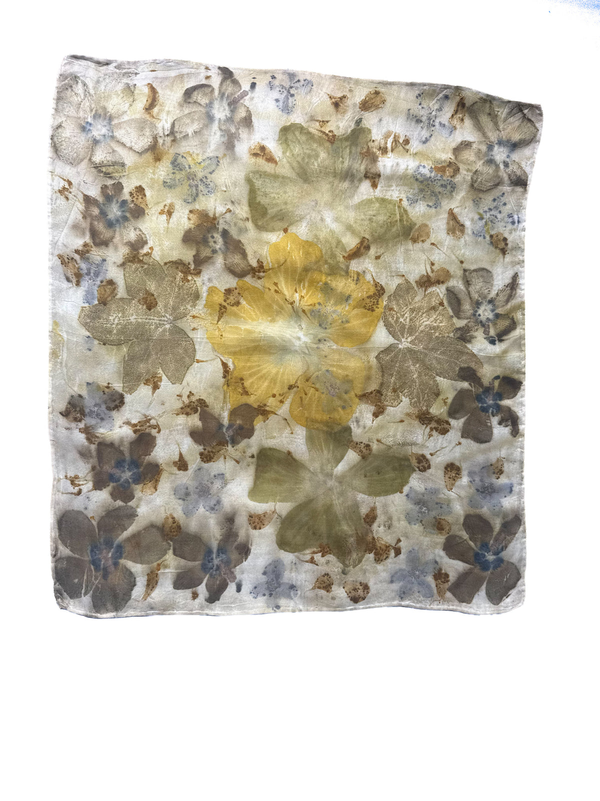 A square scarf featuring a vintage-style floral pattern with pressed flower elements in muted yellow, olive green, brown, and dusty blue on a cream background.