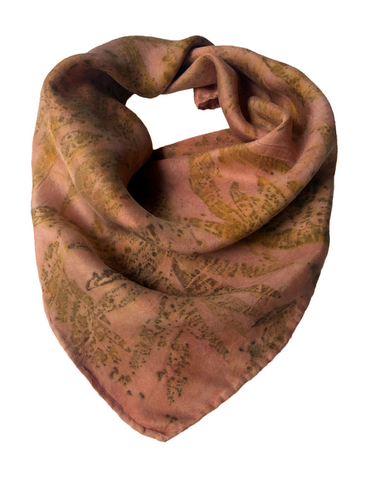 A lightweight square scarf with a distressed, vintage-style botanical pattern in muted brown and olive green on a dusty rose pink background, shown against a plain white background.
