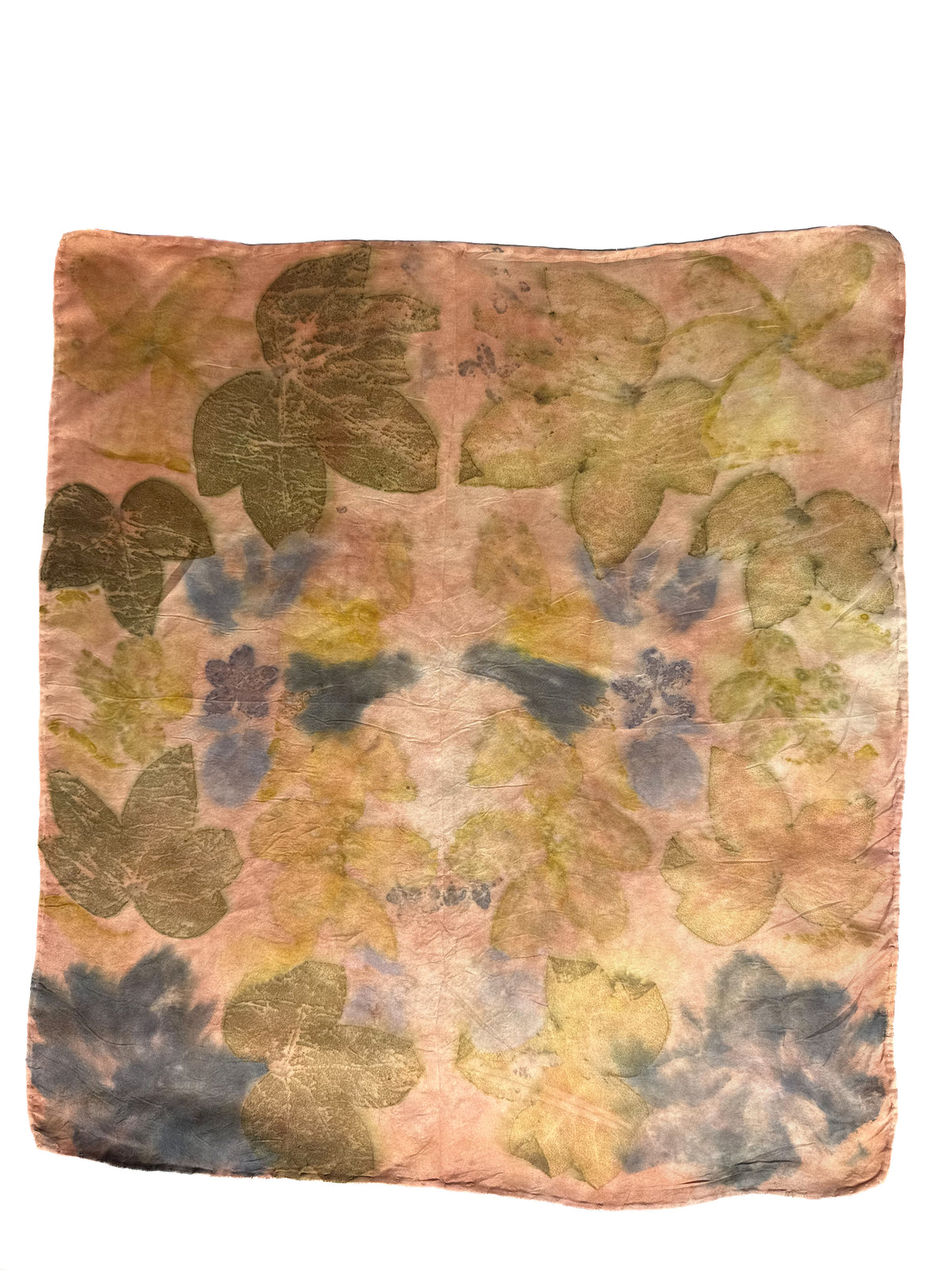 A square scarf featuring a vintage-style botanical pattern with pressed leaves in muted olive green, yellow, and slate blue over a warm peach and beige background.