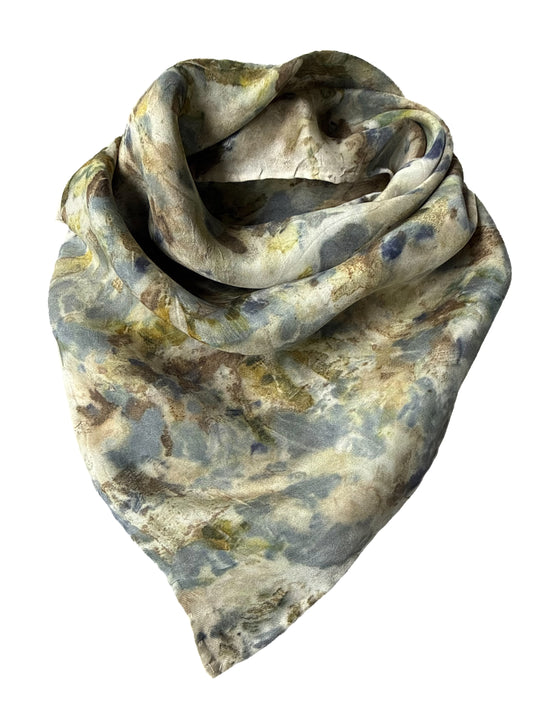 A lightweight square scarf with an abstract, painterly pattern in muted tones of gray, beige, olive green, and brown, draped against a plain white background.